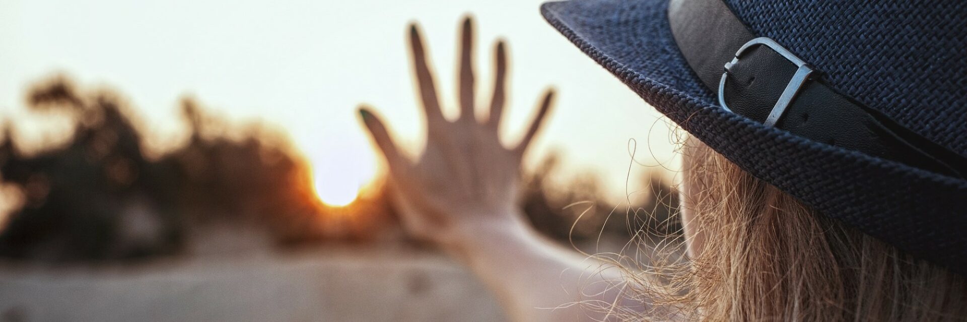 Woman with a hat touching the window