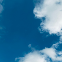 Blue sky with white clouds used as a header banner for an article about cloud first and hybrid cloud strategies.