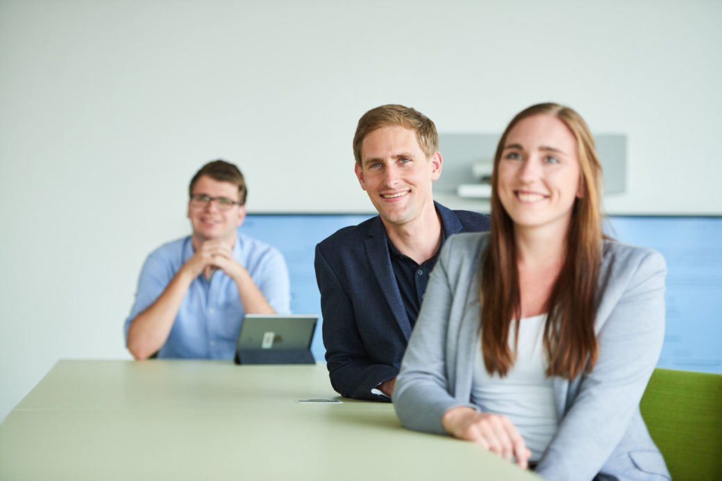 d.velop employees meet each other in conference room