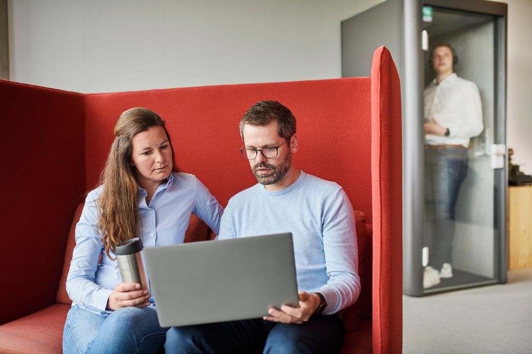 Three people working in meeting area