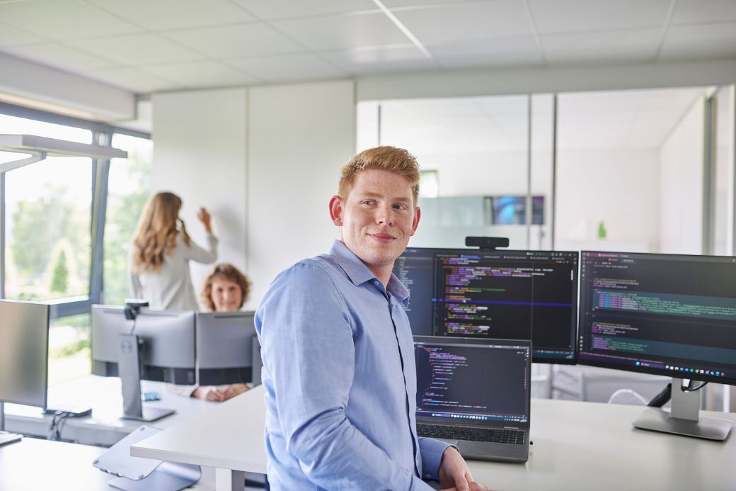 Employee in front of multiple screens