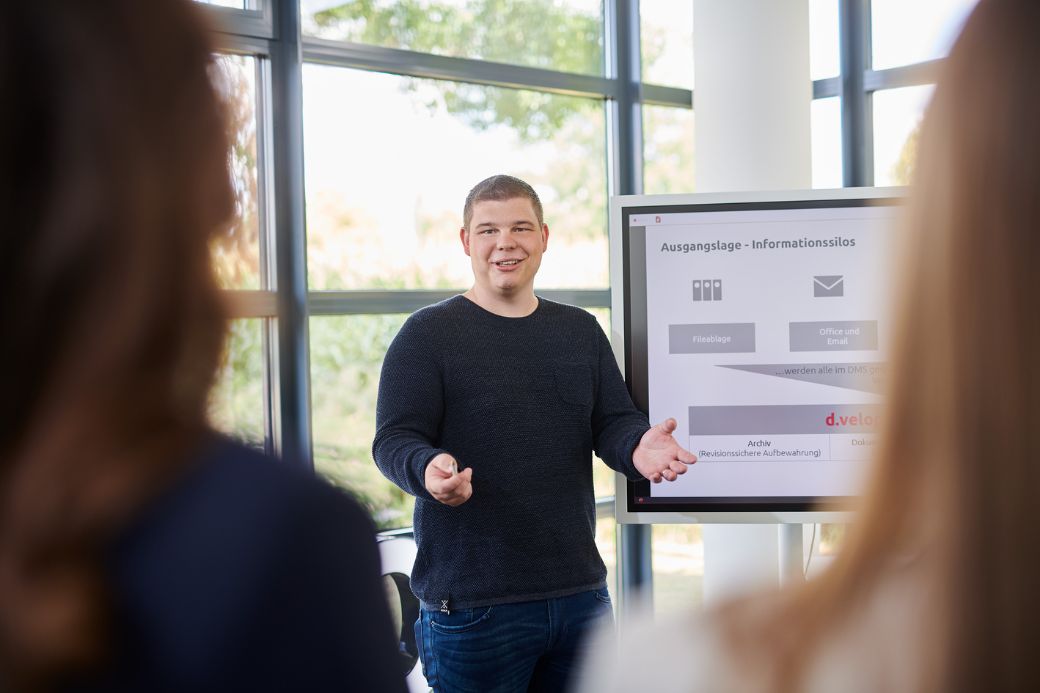 Two people watching presentation