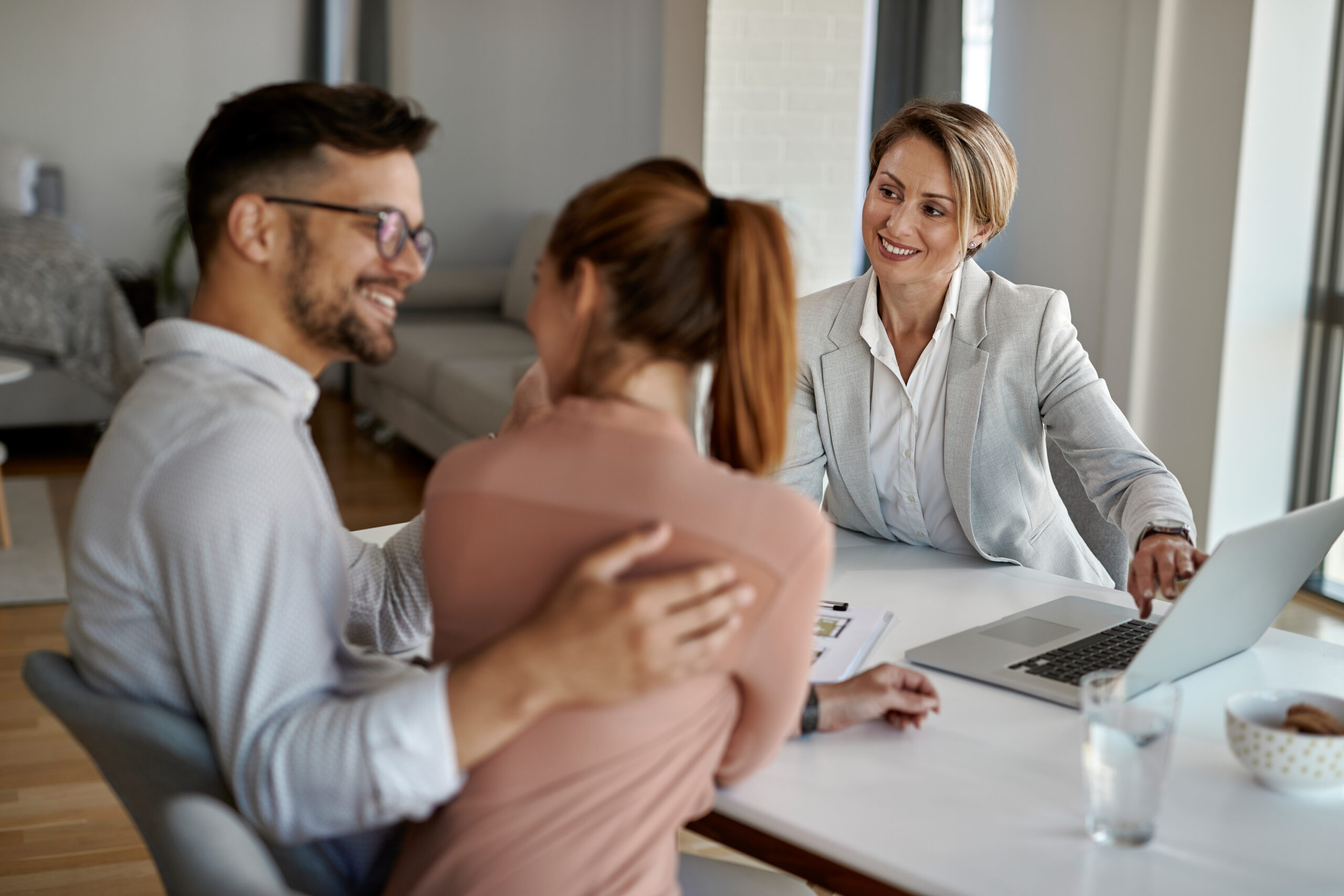 Real estate agent having meeting with a couple in the office.