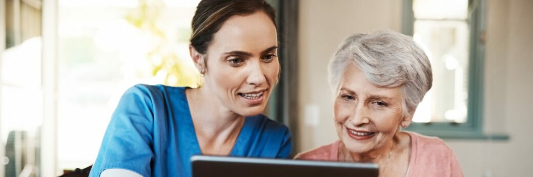 Shot of a young nurse and senior woman using a digital tablet at breakfast time in a nursing home