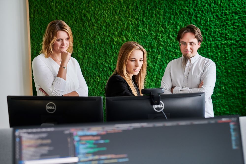 Three people working at a desk together