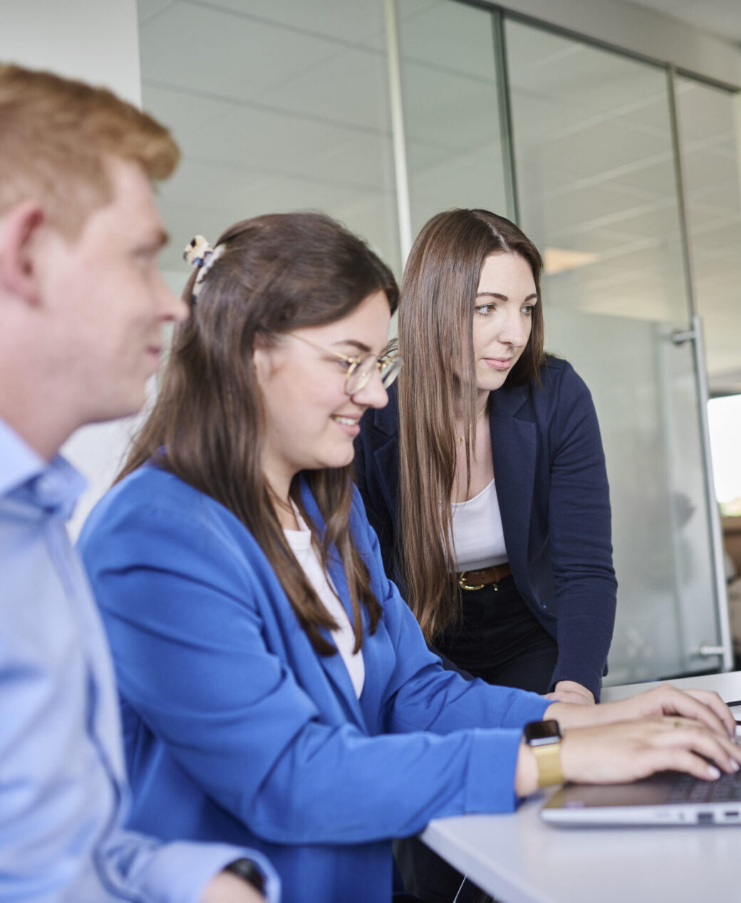Three d.velop employees during an onboarding session at the workplace